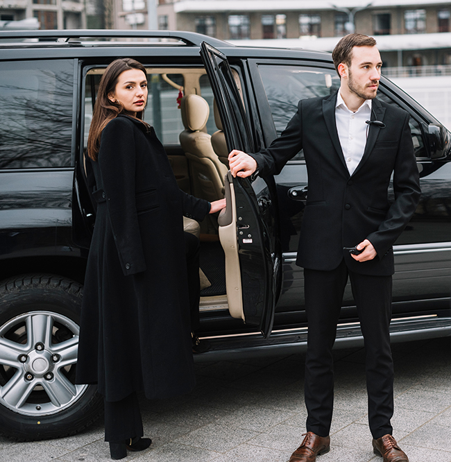 Chauffeur opening luxury S-Class vehicle door